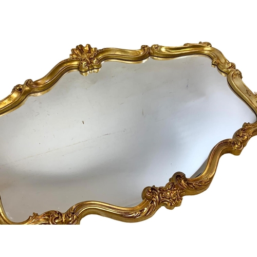 219 - A large ornate gilt framed 18th century style mirror. 106 x 81cm