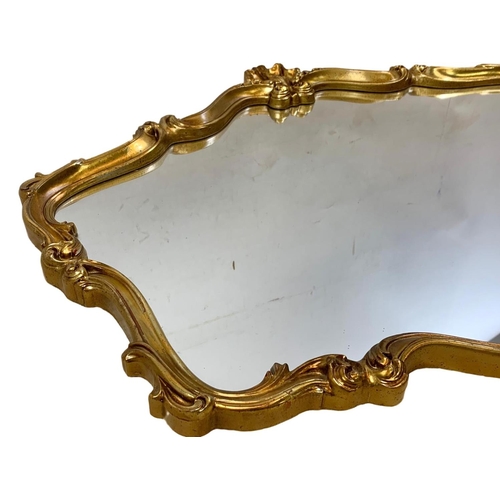 219 - A large ornate gilt framed 18th century style mirror. 106 x 81cm