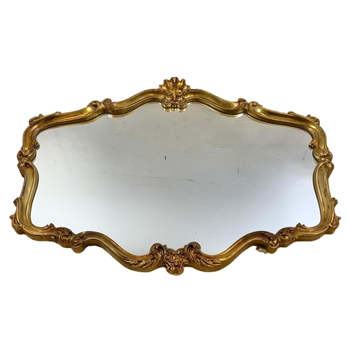 219 - A large ornate gilt framed 18th century style mirror. 106 x 81cm