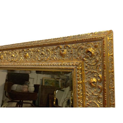 225 - A large ornate gilt frame mirror. 110 x 80cm.