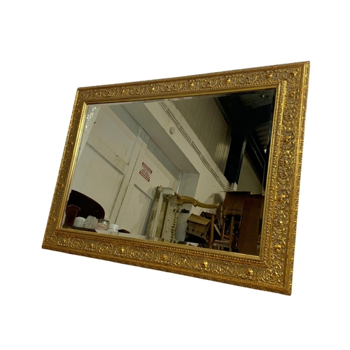 225 - A large ornate gilt frame mirror. 110 x 80cm.