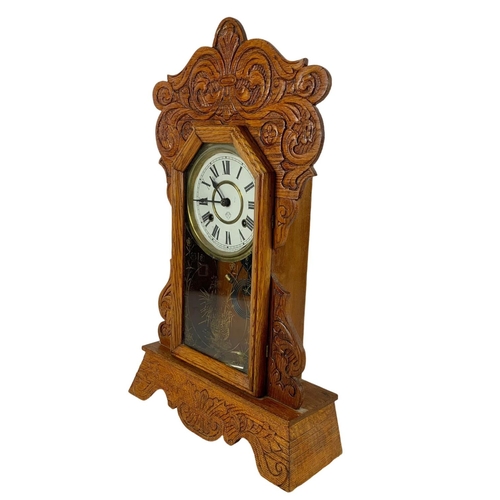 236 - A late 19th century American oak gingerbread clock. Circa 1880. 34 x 57cm.