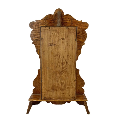 236 - A late 19th century American oak gingerbread clock. Circa 1880. 34 x 57cm.