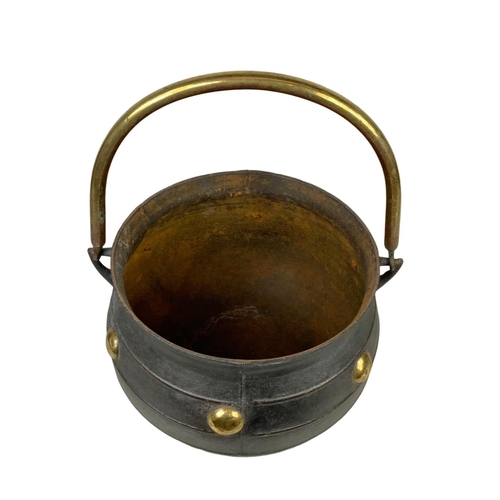 243 - A large early 20th century cast iron and brass 3 legged pot. 36 x 32 x 53cm including handle