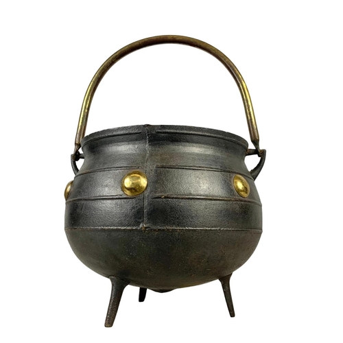 243 - A large early 20th century cast iron and brass 3 legged pot. 36 x 32 x 53cm including handle