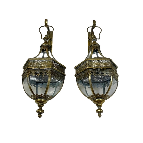 246 - A pair of 19th century style ornate brass wall hanging lanterns. 64cm