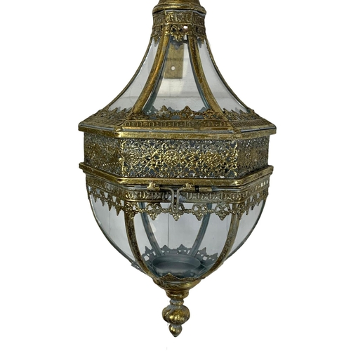 246 - A pair of 19th century style ornate brass wall hanging lanterns. 64cm