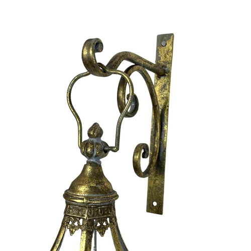 246 - A pair of 19th century style ornate brass wall hanging lanterns. 64cm