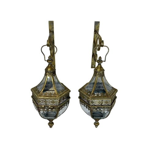 246 - A pair of 19th century style ornate brass wall hanging lanterns. 64cm