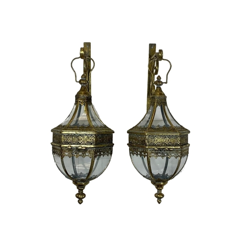 246 - A pair of 19th century style ornate brass wall hanging lanterns. 64cm