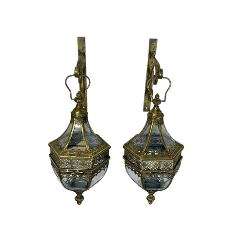 247 - A pair of 19th century style ornate brass wall hanging lanterns. 64cm.