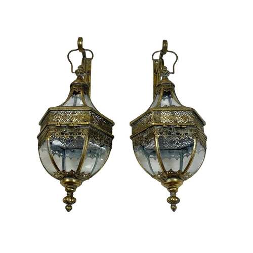 247 - A pair of 19th century style ornate brass wall hanging lanterns. 64cm.