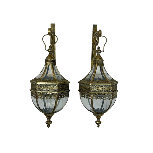 247 - A pair of 19th century style ornate brass wall hanging lanterns. 64cm.