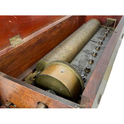 256 - A Victorian music box with key. Case simulating coromandel wood. Circa 1850. 44.5 x 16.5 x 12cm.