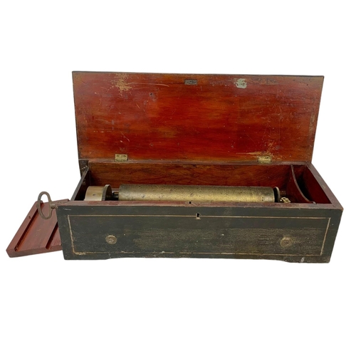 256 - A Victorian music box with key. Case simulating coromandel wood. Circa 1850. 44.5 x 16.5 x 12cm.