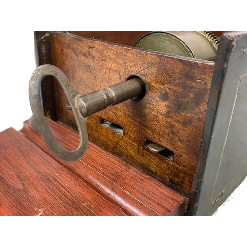 256 - A Victorian music box with key. Case simulating coromandel wood. Circa 1850. 44.5 x 16.5 x 12cm.