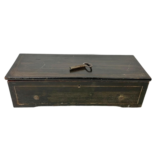 256 - A Victorian music box with key. Case simulating coromandel wood. Circa 1850. 44.5 x 16.5 x 12cm.