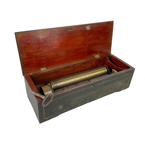 256 - A Victorian music box with key. Case simulating coromandel wood. Circa 1850. 44.5 x 16.5 x 12cm.