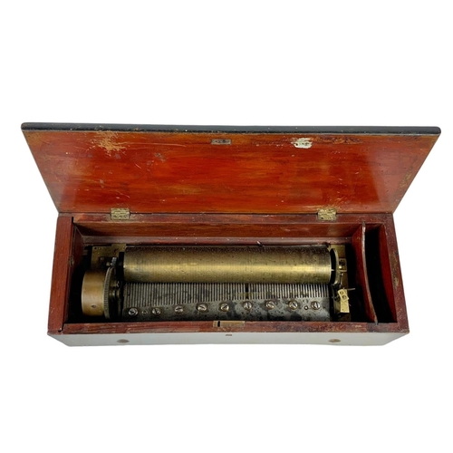 256 - A Victorian music box with key. Case simulating coromandel wood. Circa 1850. 44.5 x 16.5 x 12cm.