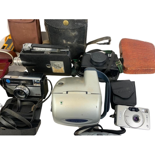 263 - Quantity of cameras. Including Kodak, Canon, Regula, Halina, Polaroid, Hanimex.