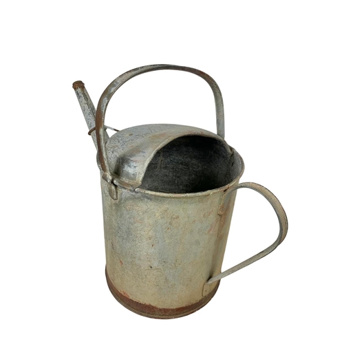 282 - A large early 20th century galvanised tub and a watering can. 85 x 55 x 32