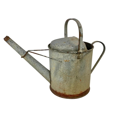 282 - A large early 20th century galvanised tub and a watering can. 85 x 55 x 32