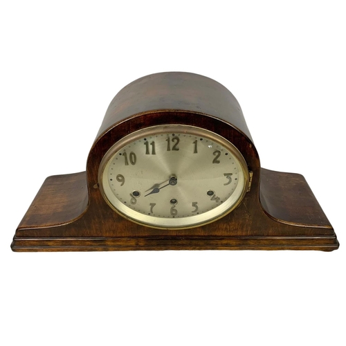 342 - A vintage mantle clock with key and pendulum. 51 x 24.5cm.