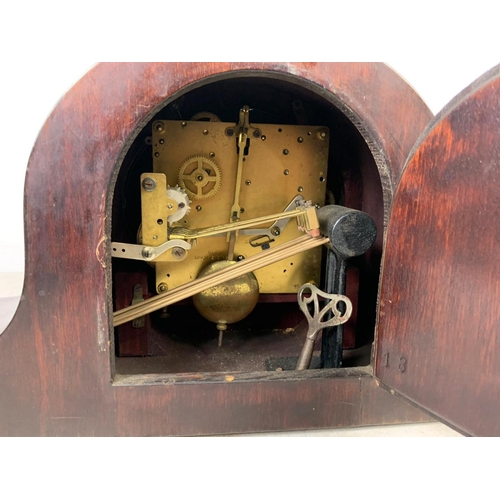 342 - A vintage mantle clock with key and pendulum. 51 x 24.5cm.