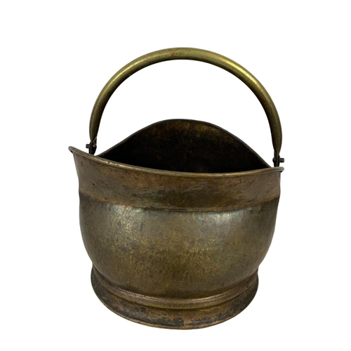 343 - A Victorian cast iron door handle and a vintage brass coal scuttle. Scuttle measures 34 x 36cm.