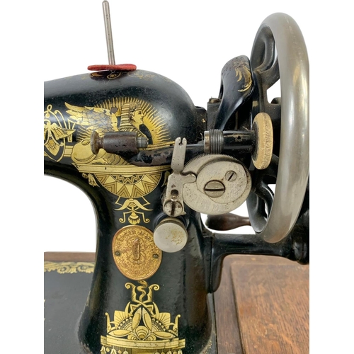 346 - An early 20th century wind up Singer sewing machine 51 x 34cm.