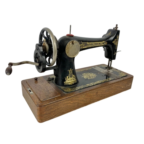 346 - An early 20th century wind up Singer sewing machine 51 x 34cm.