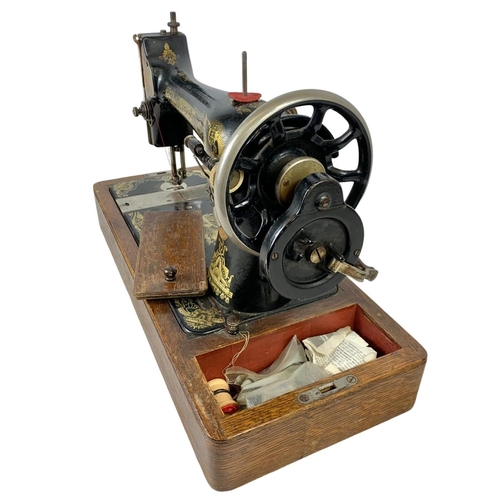 346 - An early 20th century wind up Singer sewing machine 51 x 34cm.