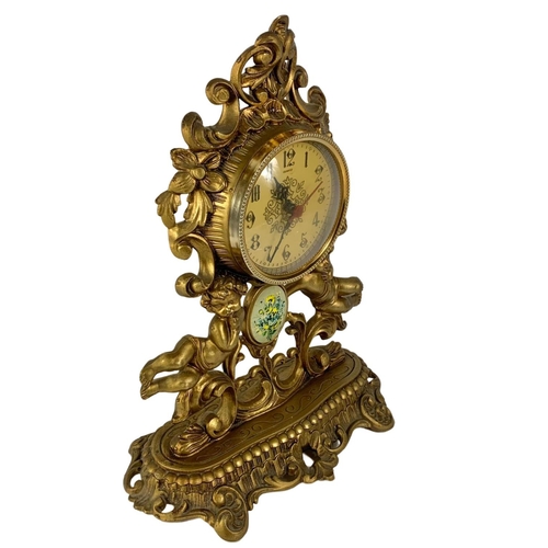 467 - Ornate gilt mantle clock with cherubs. 31 x 40cm.