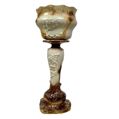 487 - An early 20th century pottery jardiniere on stand. 73cm