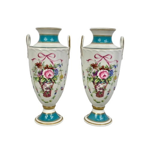 520 - A pair of Mintons Rose Basket porcelain urns. 22cm.