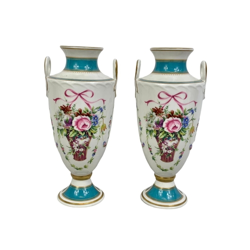 520 - A pair of Mintons Rose Basket porcelain urns. 22cm.