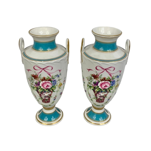 520 - A pair of Mintons Rose Basket porcelain urns. 22cm.