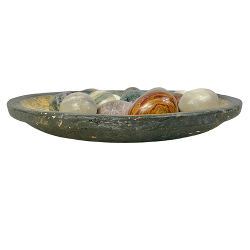 564 - Marble stones on a large decorative terracotta bowl. Bowl measures 41cm