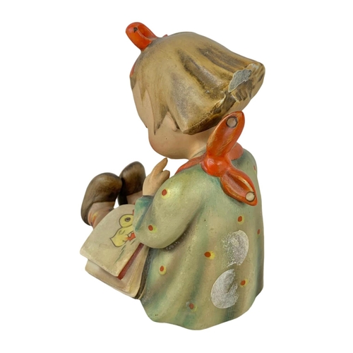 596 - A vintage M. J. Hummel Goebel pottery figure. “Bookworm” Germany 1930. 10 x 12cm