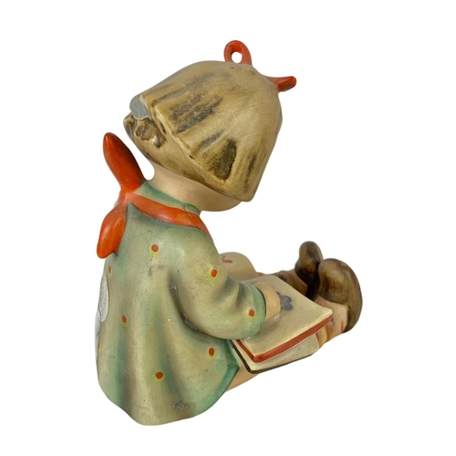 596 - A vintage M. J. Hummel Goebel pottery figure. “Bookworm” Germany 1930. 10 x 12cm