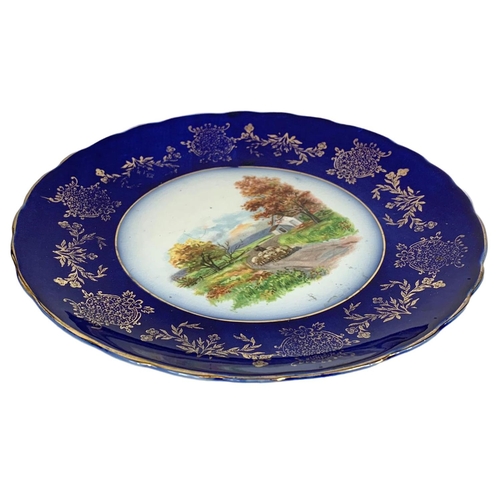 606 - A pair of Victorian colt blue hand painted plates with gilt decoration. By Woods & Son. 22cm