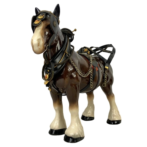 608 - A large porcelain shire horse and wooden cart. Total length 67cm. Horse measures 34 x 29cm.