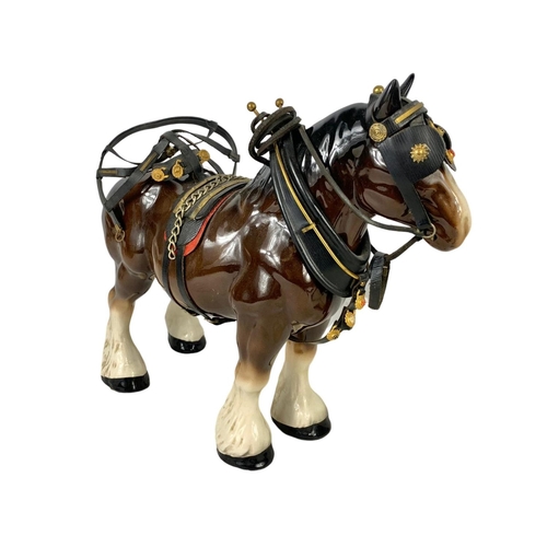 608 - A large porcelain shire horse and wooden cart. Total length 67cm. Horse measures 34 x 29cm.