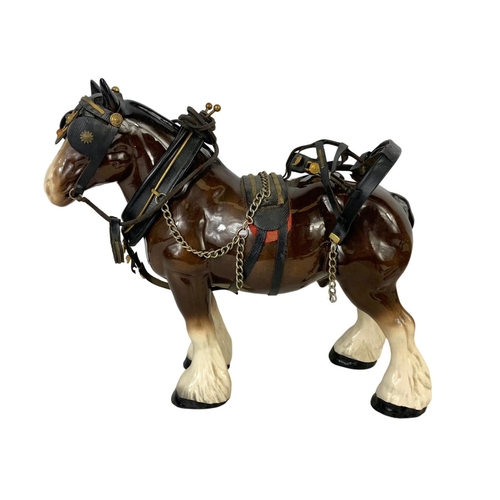 608 - A large porcelain shire horse and wooden cart. Total length 67cm. Horse measures 34 x 29cm.