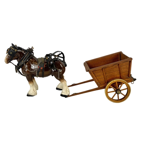 608 - A large porcelain shire horse and wooden cart. Total length 67cm. Horse measures 34 x 29cm.