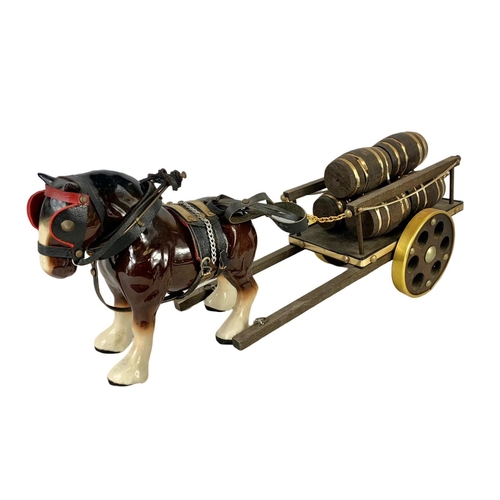 609 - A large porcelain shire horse and wooden cart. Total length 60cm. Horse measures 25 x 19cm. Cart mea... 