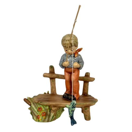 613 - A first issue M. J. Hummel Goebel pottery figure “The Angler” number 566. 13 x 19cm.