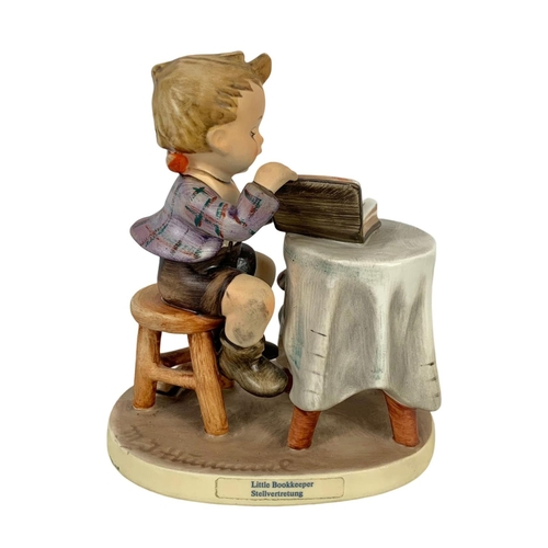 618 - M. J. Hummel Goebel pottery figure “Little Bookkeeper” number 303. 10 x 12.5cm.