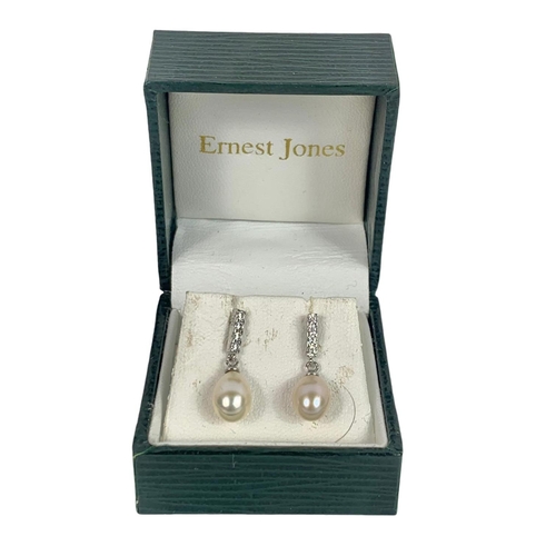 653 - Pair of silver and pearl earrings and a silver necklace.