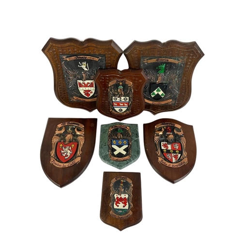 94 - 7 wall mounted family crests. Largest 30 x 37cm